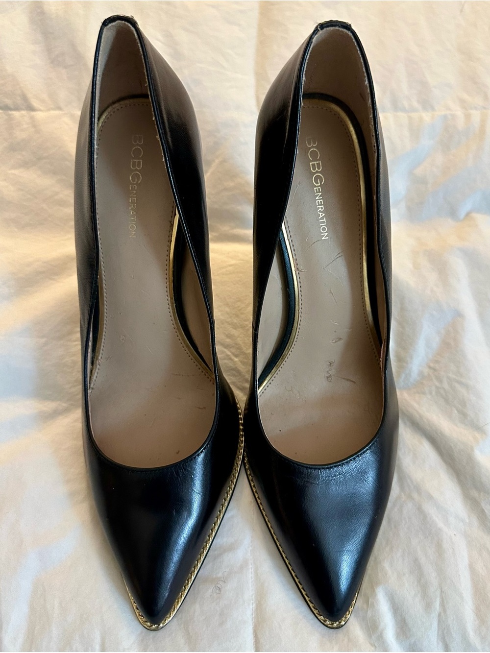 BCBGeneration Black Pointed Toe Pumps with Gold Trim